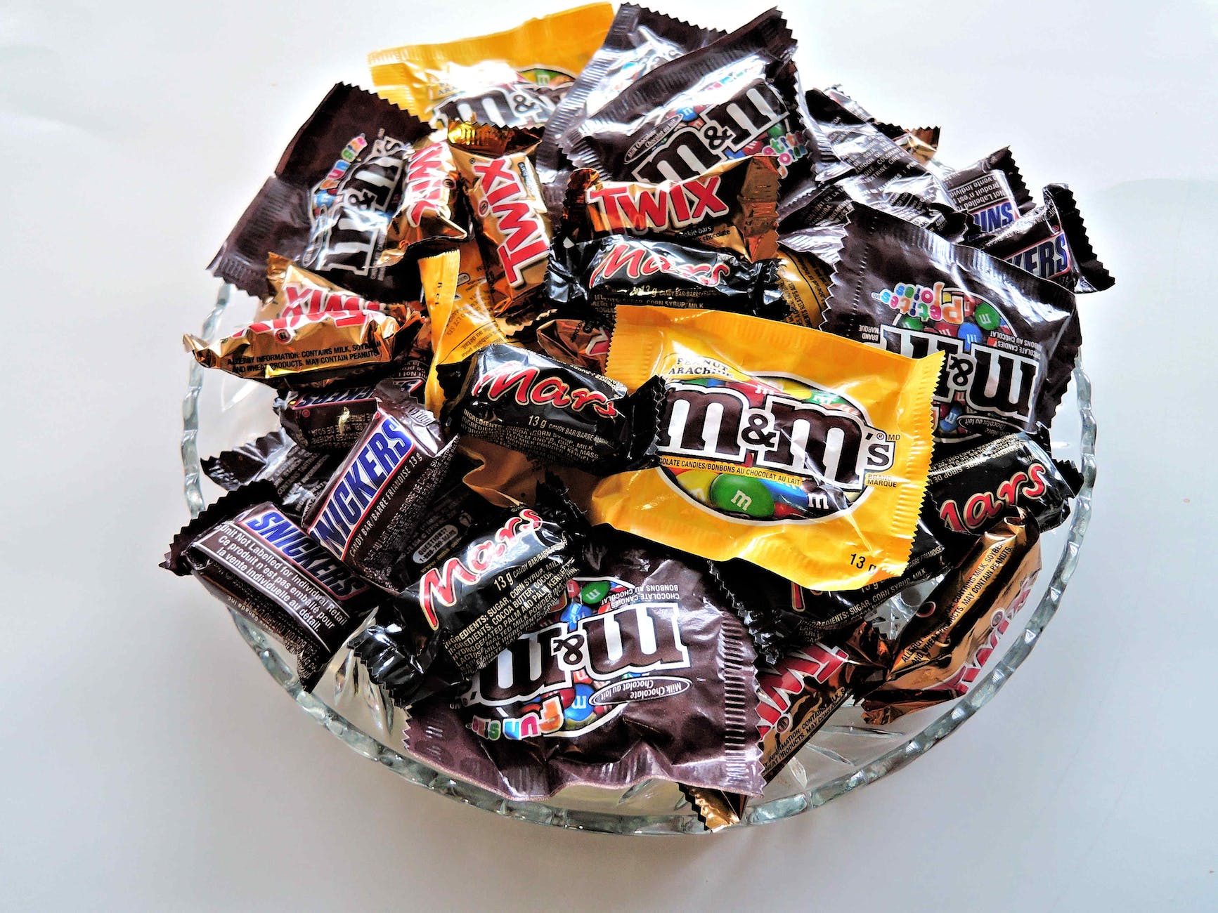 m and m on clear cut glass bowl