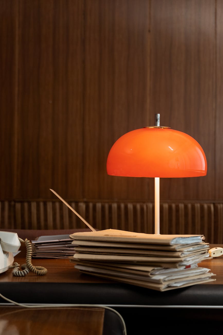 an orange lamp on a desk